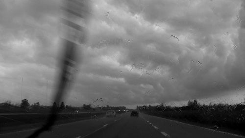 Highway driving with rain and stormclouds. Black & white.Highway 416. Ontario, Canada. HD.