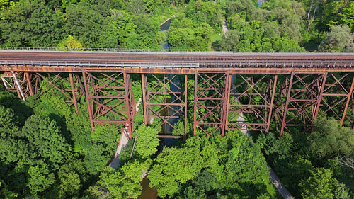 Drone shot of train bridge stock footage. E.T. Seton Park, Toronto, Canada. 4K.