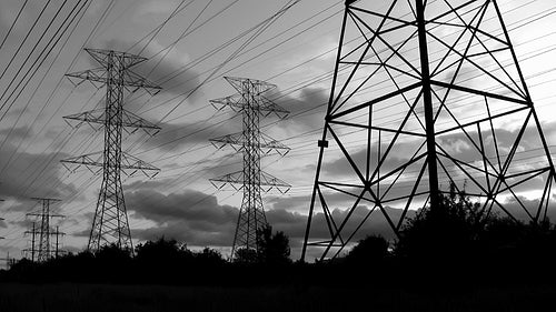 Hydro electric towers at sunset. Time lapse. Toronto, Ontario, Canada. Black & white. HD.