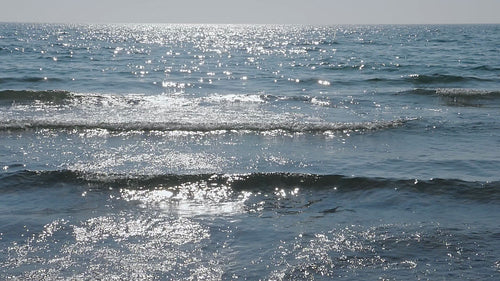 Slow motion sunlit waves coming into shore. Lake Ontario, Canada. HD video.