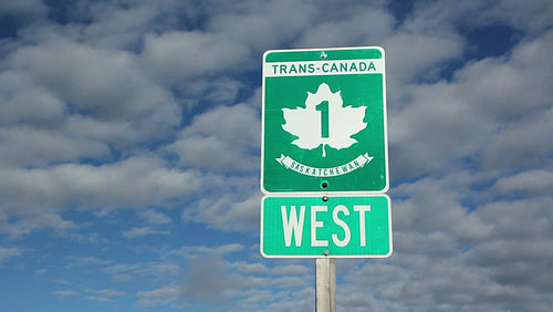 Trans Canada Highway 1 sign. Saskatchewan, Canada. Time lapse clouds. HD.