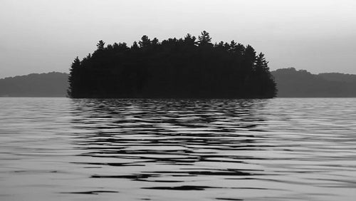 Morning island at dawn with water reflections. Black and white. HD video.