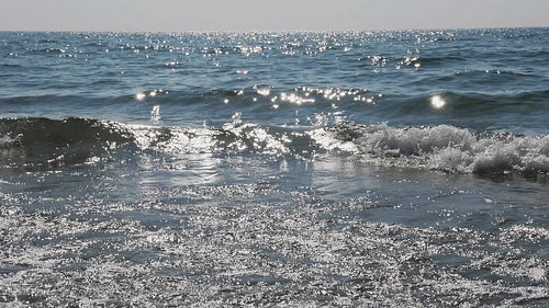 Slow motion sunlit waves breaking. Shore of Lake Ontario, Canada. HD video.