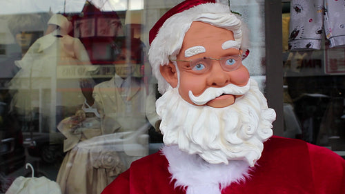 Robot santa dances outside store. Detail of face. Toronto, Ontario, Canada. HD video.