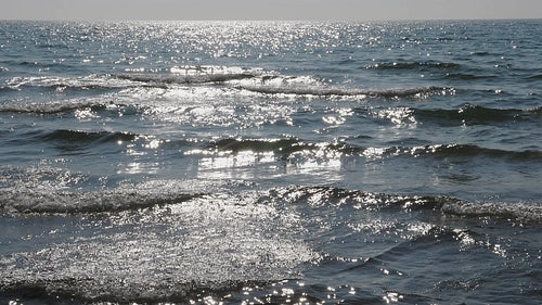 Slow motion sunlit waves coming into shore. Lake Ontario, Canada. HD video.