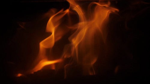 Slow motion yellow and orange flames. Closeup through smoky glass. HD.