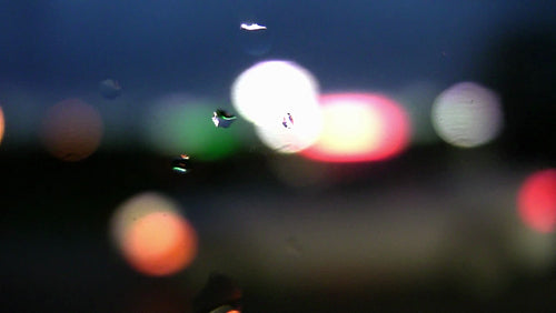 Rainy highway drive. Defocused lights. Wet side window. HDV footage. HD.