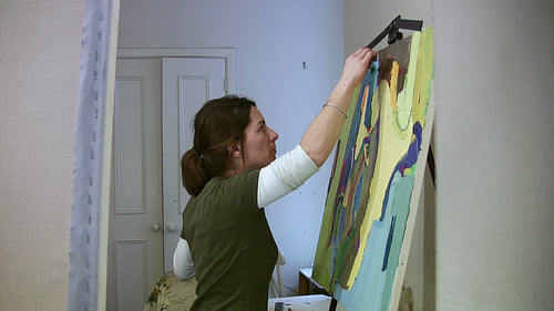 Artist working in the studio. Wide shot. HD video.