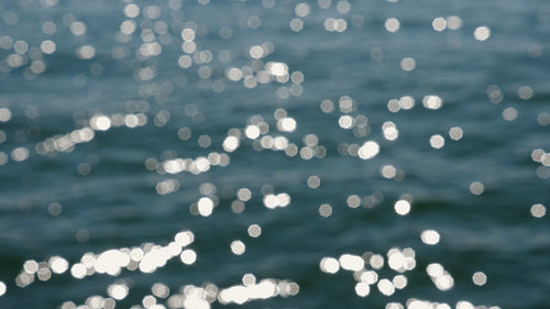 Slo mo defocused highlights on blue sunlit lake water. Lake Ontario, Canada. HD stock video.