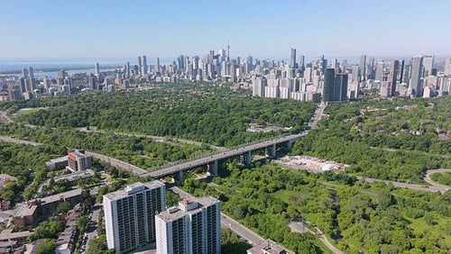 Drone aerial. Stock video footage of Bloor Viaduct and Toronto skyline. 4K.