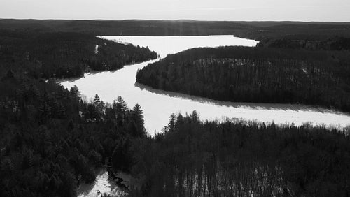 Sunny winter morning aerial drone shot. Winter on Drag Lake, Ontario. Black and white. 4K.