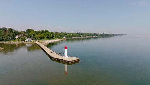 Drone aerial. Stock video circling lighthouse and pier. Summer in Oakville. 4K.