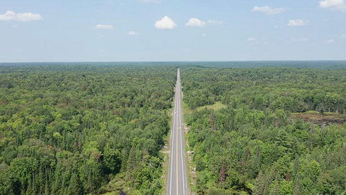 Drone aerial of summer highway with cars. Rural landscape in Ontario, Canada. 4K.