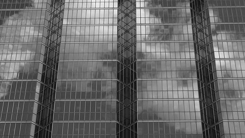 Office windows reflect steam. Black and white. HD video.