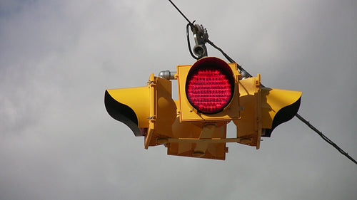 Flashing stoplight. Grey sky background. HDV footage. HD.