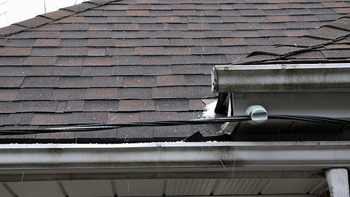 Ice pellets falling on roof. Detail of asphalt shingles. Winter in Toronto, Canada. 4K.