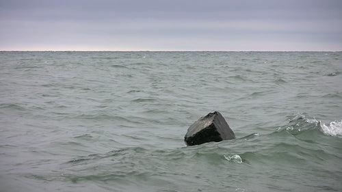 Block of concrete with moody lake. Lake Ontario, Canada. HD video.