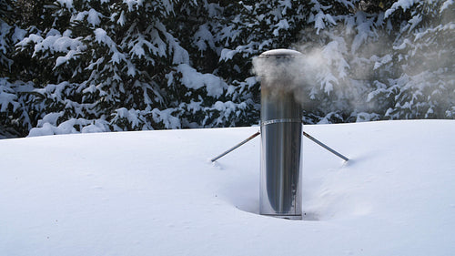 Winter chimney with wood smoke and snowy roof. Rural Ontario, Canada. 4K.