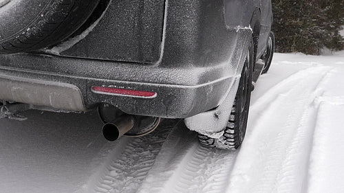 Slow motion snow with Winter SUV. Detail of bumper and tires. Canada. HD.