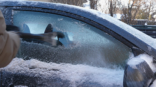 Scraping ice from car window. Winter driving in Toronto, Canada. 4K.