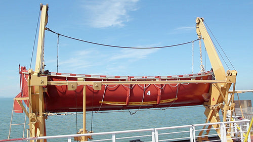 Orange lifeboat. Ferry crossing the St. Lawrence river. HD.